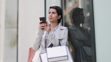Arabic woman using a smartphone on a shopping trip