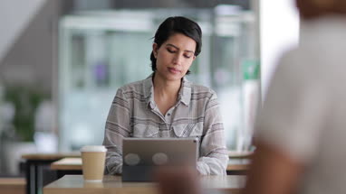 Arabic businesswoman using a digital tablet in a cafe