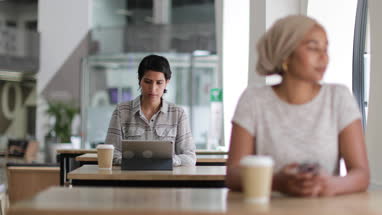 Arabic businesswoman using a digital tablet in a cafe