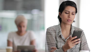 Arabic female using a smartphone in a cafe