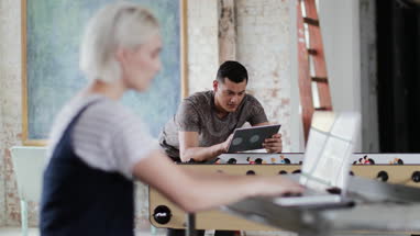 Young adult male using digital tablet in a creative office
