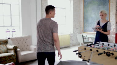 Young adults using digital tablet in a creative office