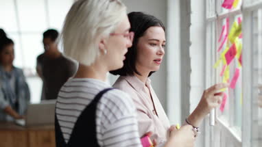 Young adults planning in a creative office with adhesive notes