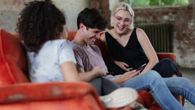 Millennials watching video on smartphone together