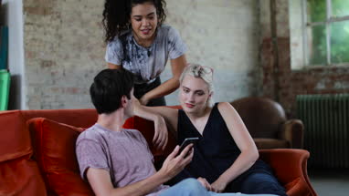 Millennials watching video on smartphone together