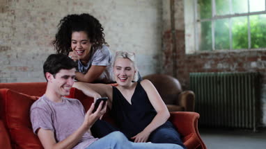Millennials watching video on smartphone together