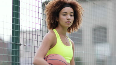 Portrait young adult female on a basketball court