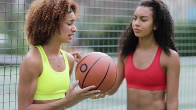 Friends taking a break from training on a basketball court