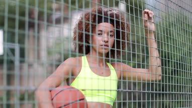 Portrait young adult female on a basketball court