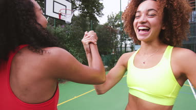 Female basketball players hi five