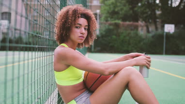 Portrait young adult female on a basketball court