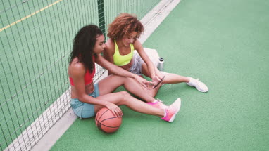 Overhead shot of friends taking a break from training on a basketball court