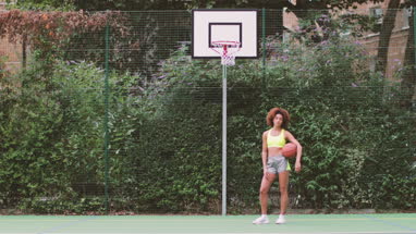 Portrait young adult female on a basketball court