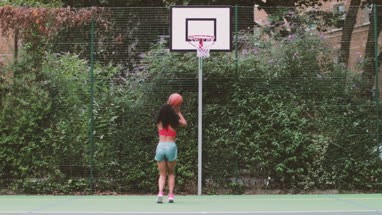 Portrait young adult female on a basketball court