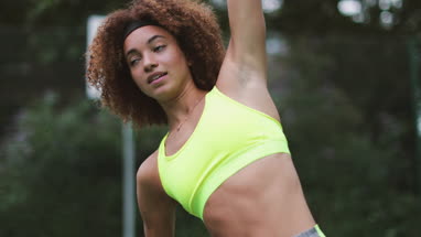 Young adult female stretching before sports
