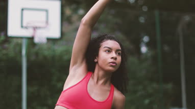 Young adult female stretching before sports