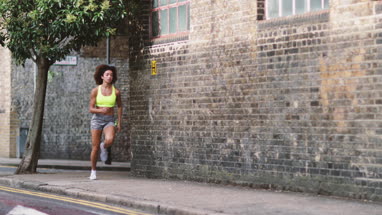 Young adult female running in urban city