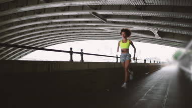 Young adult female running in city of London