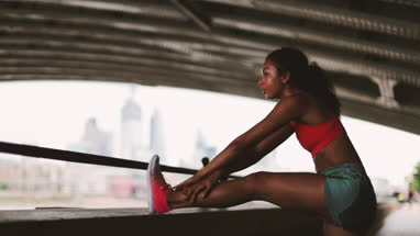 Young adult female stretching before a run