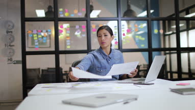 Businesswoman working late in the office on a presentation
