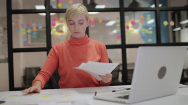 Young adult female working late in an office