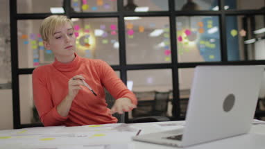 Young adult female working late in an office