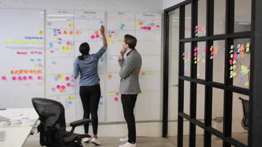 Coworkers in a late meeting working on schedule