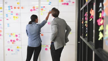 Coworkers in a late meeting working on schedule