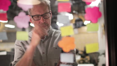 Mature businessman brainstorming ideas at night in an office