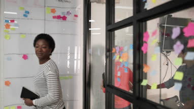 Happy coworkers leaving a team meeting