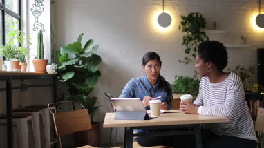 Female entrepreneurs having a meeting in a cafe