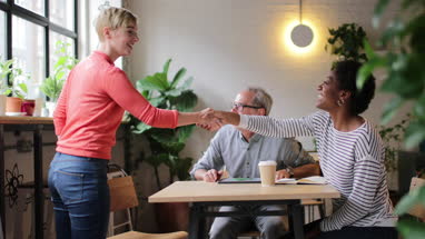 Young adult having an informal job interview in a cafe