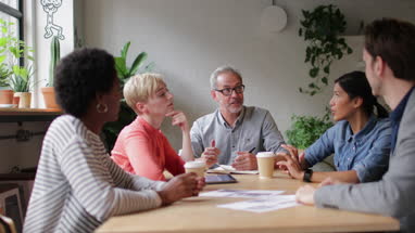 Group of coworkers having a meeting in a cafe
