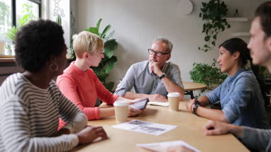 Young adult giving a presentation in a business meeting