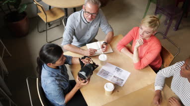 Overhead shot of coworkers discussing VR headset technology