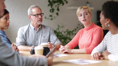 Group of coworkers having a meeting in a cafe