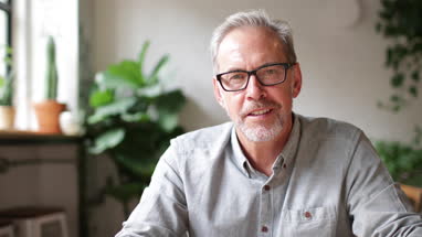 Close-up portrait of mature businessman working in a cafe