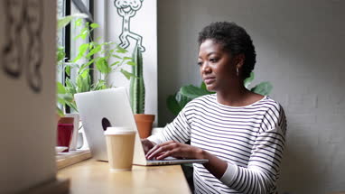 Freelance african american businesswoman working in a cafe