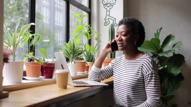 Freelance african american businesswoman working in a cafe