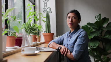 Portrait of freelance businesswoman working in a cafe