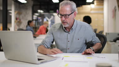 Mature male working late in an office