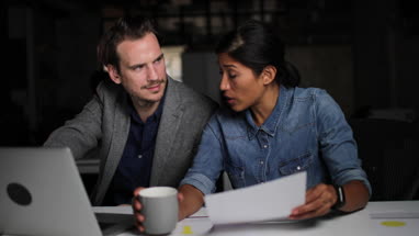 Coworkers working late in the office