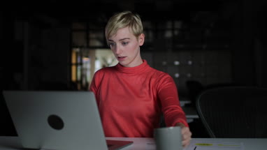 Young adult female working late in an office