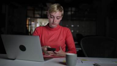 Young adult female working late in an office