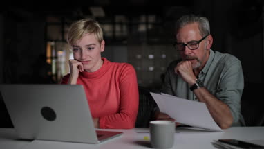 Colleagues working late at night problem solving