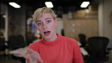 Young adult businesswoman on a videocall in an office