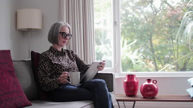 Mature adult female using a digital tablet