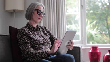 Mature adult female using a digital tablet