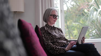 Mature adult female using a digital tablet