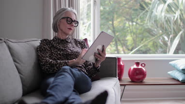 Mature adult female using a digital tablet